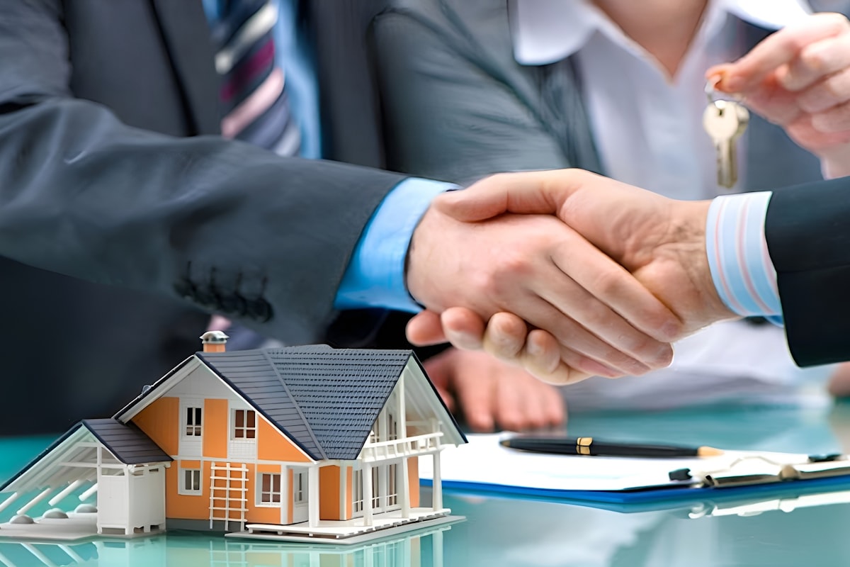 Real estate agent handing over house keys to new homeowners